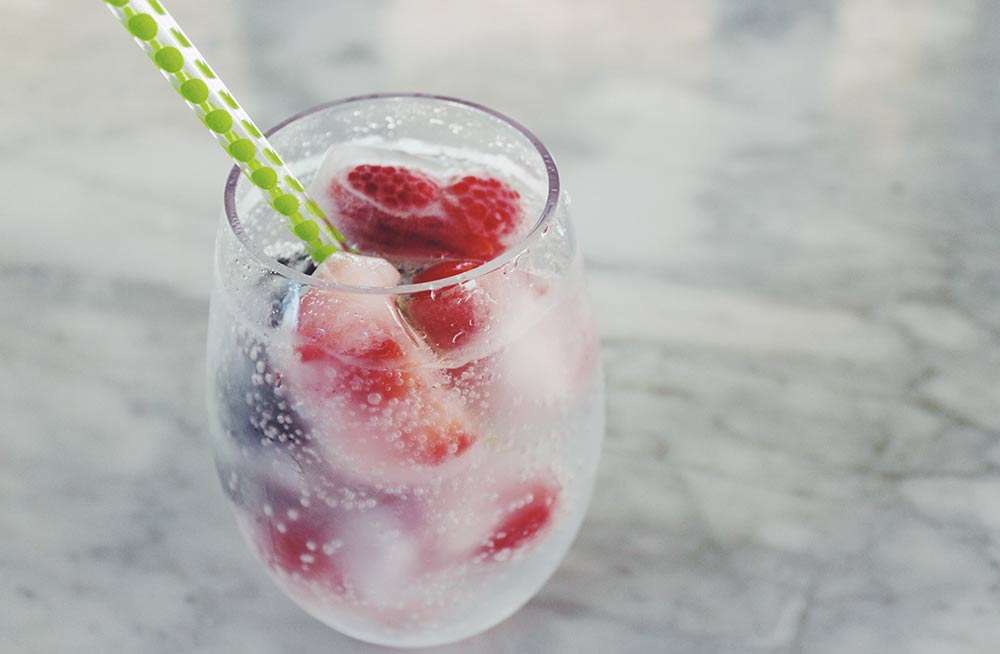 cold beverage with fruit ice cubes
